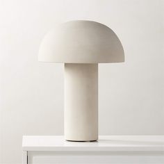 a white table lamp sitting on top of a counter