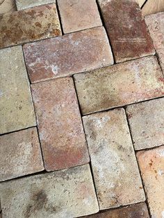 a cat laying on top of a pile of bricks