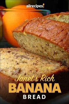 a loaf of banana bread sitting on top of a white plate next to an orange