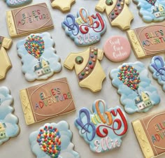 baby shower cookies are arranged on a table with balloons and hot air balloons in the sky