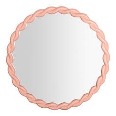 a round mirror with pink braids on the edges and a white backround