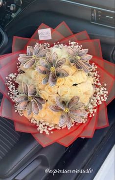 a bouquet of flowers sitting on top of a car dashboard