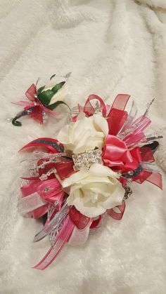 two bridal bouquets sitting on top of a white blanket