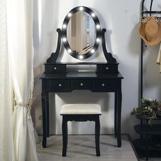 a dressing table with a mirror and stool