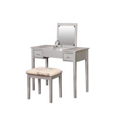 a white vanity with a stool and mirror