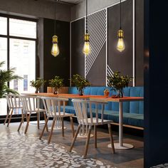 a dining room with blue couches and wooden tables