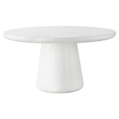 a white cake plate sitting on top of a tablecloth covered pedestal with no one around it