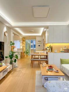 a living room filled with furniture and a flat screen tv sitting on top of a hard wood floor