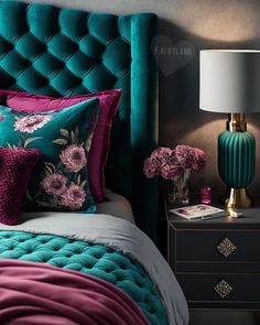 a green velvet headboard with pink flowers on it and two nightstands next to it