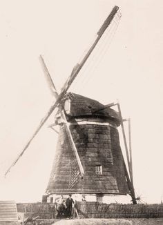 an old black and white photo of a windmill