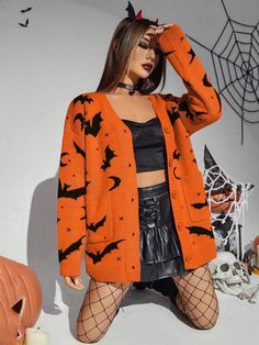 a woman wearing an orange cardigan with black bats on it and net tights