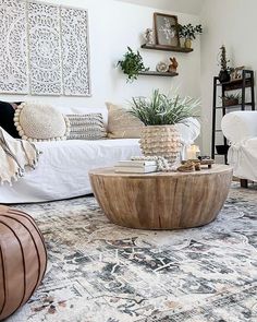 a living room filled with lots of furniture and decor on top of carpeted flooring