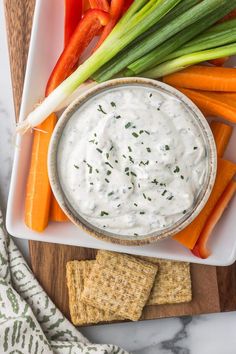 carrots and celery sticks with dip in a bowl