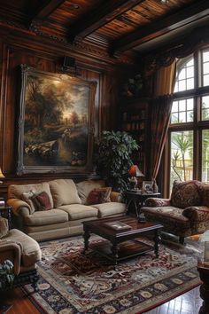 a living room filled with furniture and a painting hanging on the wall above it's windows