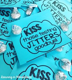 some blue and silver candy wrappers on top of each other with the words kiss those testing