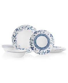 blue and white dinnerware set with swirl designs on the rims, in various shapes and sizes