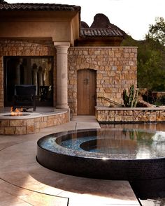 an outdoor fire pit in the middle of a patio