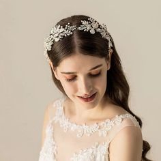 a woman wearing a wedding dress and headpiece