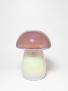 a white and pink mushroom sitting on top of a table