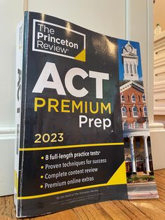 the princeton review act premium prep guide sits on top of a wooden table in front of a building