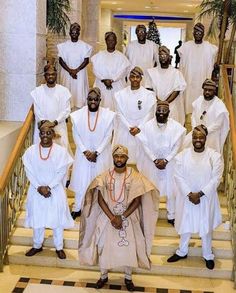 a group of men standing next to each other on stairs