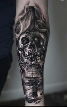 a man's leg with a skull and ship on it