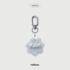 a white keychain with the word kairi printed on it and a black chain