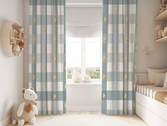 a child's bedroom with blue and white curtains