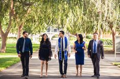 a group of business people walking down a sidewalk