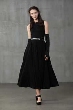 "Winter days do not mean that you need to resign to elegance. Boasting a soft wool-blend construction, this spiral skirt from Linennaive proves that you can be elegant and warm at the same time. Featuring a high waist, a rear zip fastening, a flared style, side pockets and a midi-length. 【Material】 -Wool 87%, Elastane 13% 【Length】 32-33 inches. 【Size】 *SIZE XS length: 32\"/82 cm waist: 26\"/ 66 cm *SIZE S length: 32\"/82 cm waist: 27\"/ 70 cm *SIZE M length: 32\"/82 cm waist: 29/ 75 cm *SIZE L l Elegant Asymmetrical Maxi Skirt For Fall, Black A-line Maxi Skirt For Winter, Winter Party Midi Length Skirt, Black Evening Skirt For Winter, Winter Evening Midi Skirt, Elegant Evening Maxi Skirt For Fall, Elegant Winter Party Maxi Skirt, Chic Black Maxi Skirt For Winter, Elegant Full Maxi Skirt For Winter