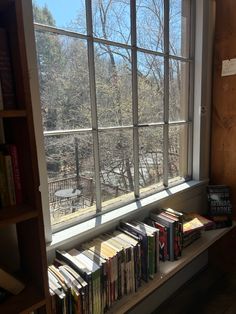 the books are lined up on the window sill