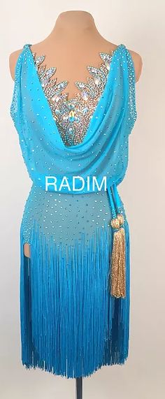 a blue dress with sequins and fringe on the bottom, in front of a mannequin's head