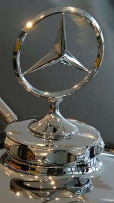 the mercedes logo is shown on top of a car's hood ornament