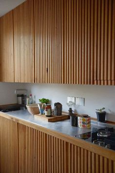 the kitchen counter is lined with pots and pans, including one potted plant