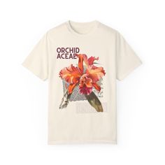 🌸 Blossom in style with our Orchid Graphic Tee! 🌸 This trendy summer top features a stunning floral design on soft, breathable white cotton, making it the perfect casual t-shirt for any occasion. It's not just a shirt; it's a piece of wearable art that brings joy and elegance to your wardrobe. Treat yourself or gift this charming tee to someone special. Feel the beauty of orchids and radiate confidence and grace wherever you go. Order now and let your style bloom! Introducing our stunning Orch Trendy Tees For Women, Botanical Style Relaxed Fit Graphic Print Shirt, Relaxed Fit Botanical Graphic Print Shirt, Relaxed Fit Graphic Print Shirt For Spring, White Botanical Style Shirt With Floral Print, Botanical Graphic Print Shirt For Spring, Botanical Relaxed Fit Graphic Shirt, Botanical Style Graphic Print Shirt For Summer, Botanical Graphic Print Shirt For Summer