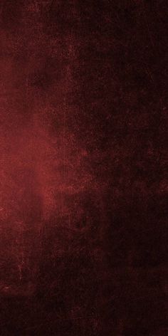 a red grungy textured background with an orange light in the middle and dark bottom