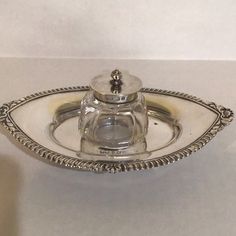 a silver plate with a glass lid on it