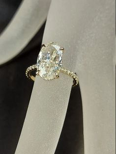 a diamond ring sitting on top of a white piece of paper