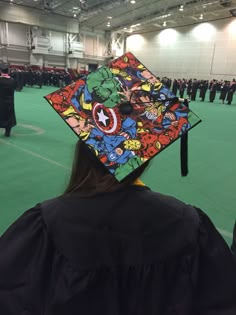 a person wearing a graduation cap with comic characters on it