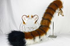 a cat tail is on display in front of a white backdrop with the word love