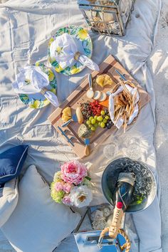 a tray full of food sitting on top of a bed next to other plates and bowls