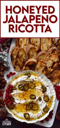 a plate with bread and olives on it next to some other foods, including bread