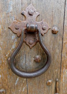 an old metal handle on a wooden door