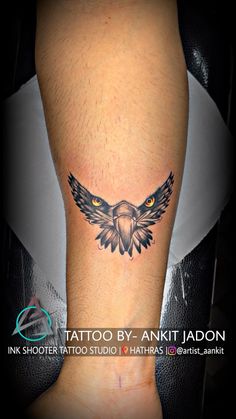 an eagle tattoo on the leg with yellow eyes and black wings is seen in this image