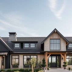 a large house with lots of windows and steps leading up to the front door area