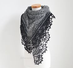 a black and white crocheted shawl on a mannequin