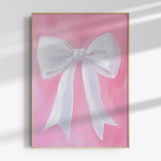 a white bow hanging on a pink wall