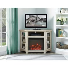 an entertainment center with a fireplace in the corner