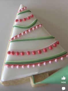 a decorated christmas tree cookie sitting on top of a table