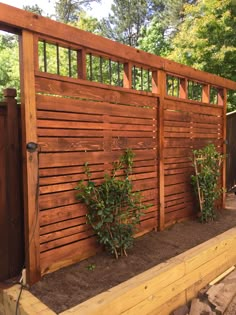 a wooden fence with plants growing in it